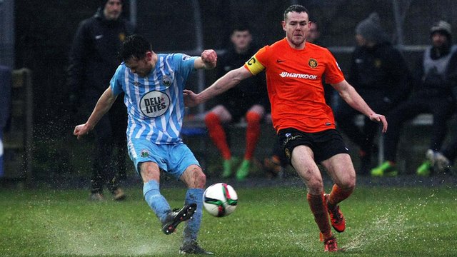Action from Warrenpoint Town against Carrick Rangers