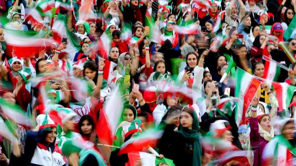 Iranian women cheer during the World Cup Qatar 2022 Group C qualification football match between Iran and Cambodia at the Azadi stadium in the capital Tehran on 10 October, 2019.