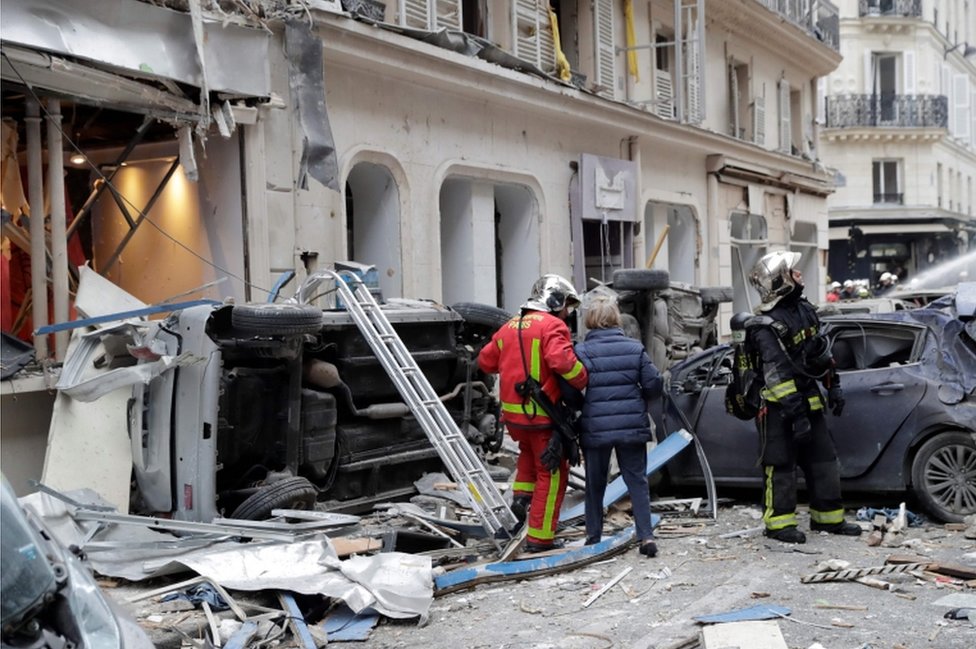 Cars lie upturned on their sides near the scene of the blast