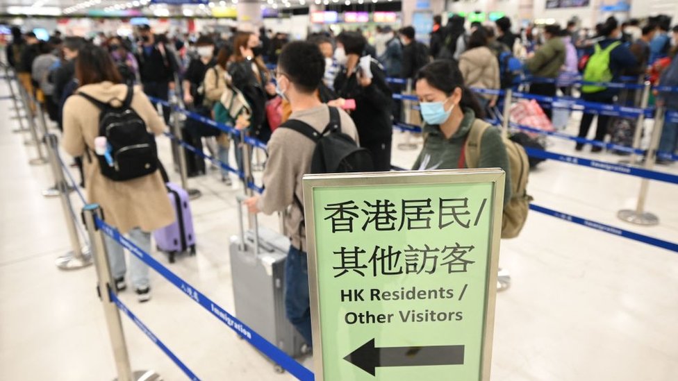 People queue up at the Lok Ma Chau checkpoint at the Shenzhen border crossing with mainland China in Hong Kong on January 8, 2023.
