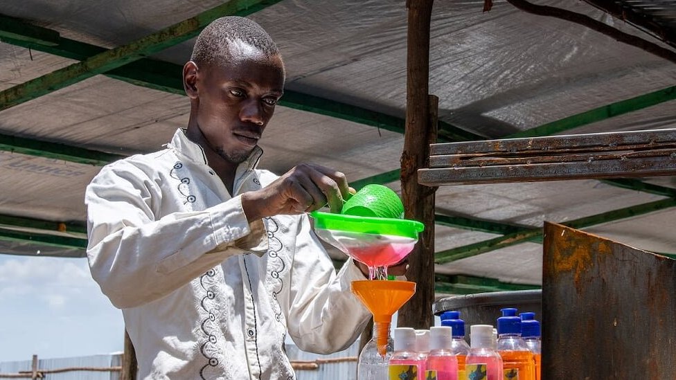 Innocent Havyariama is seen bottling some soap