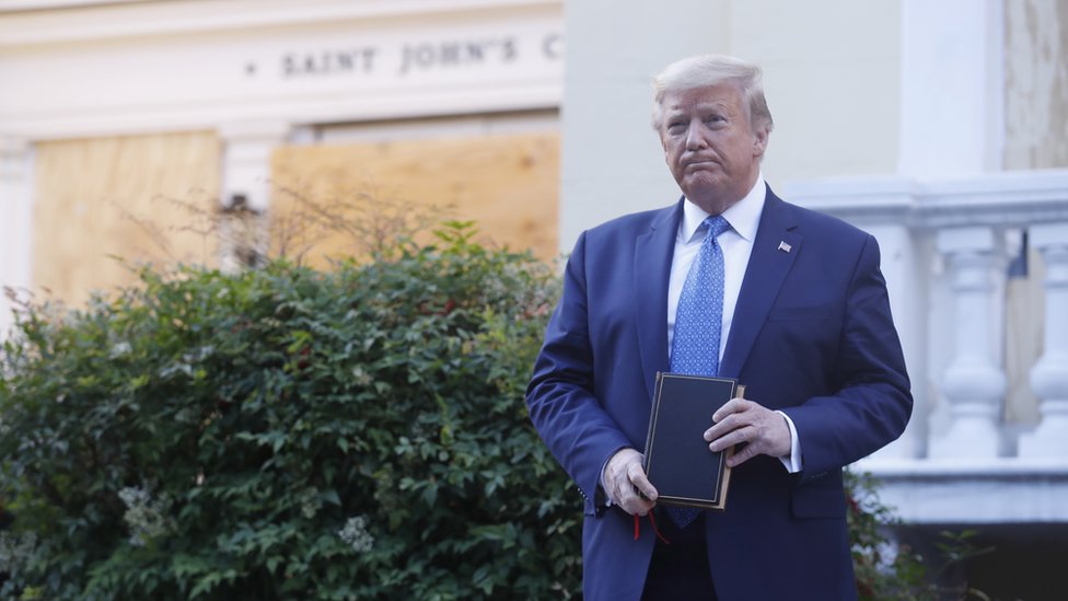 Trump posing with a Bible outside a boarded-up church