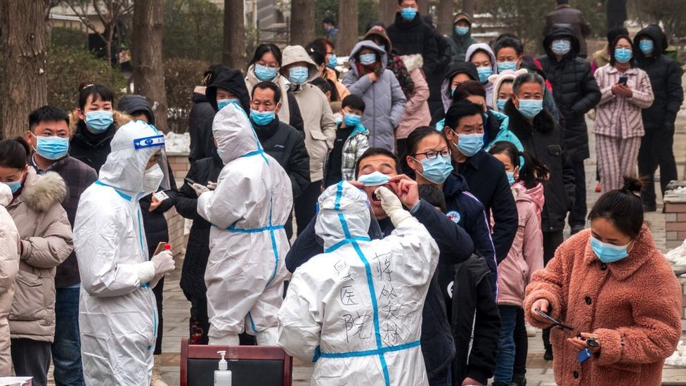 Residents queue to undergo nucleic acid tests for the Covid-19 coronavirus in Anyang in China's central Henan province