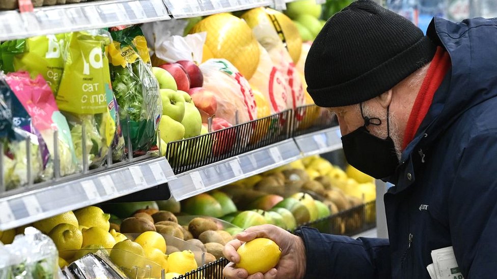 A man chooses lemons at a supermarket in Moscow.