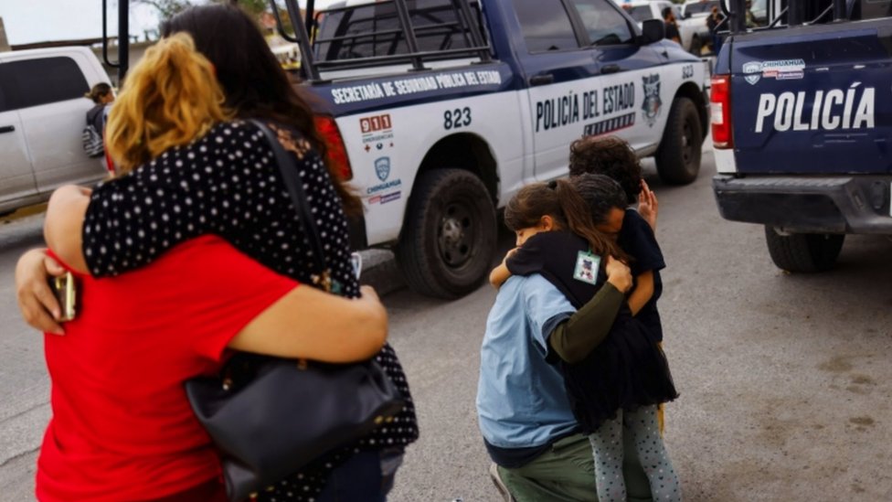 Relatives embrace outside the Ciudad Juárez prison where the fight began that later spread its violence to the streets.