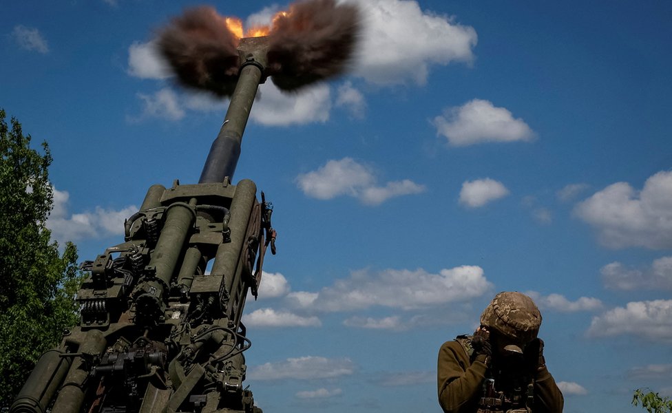 Ukrainian soldiers fire a shell from a M777 Howitzer in Donetsk Region,