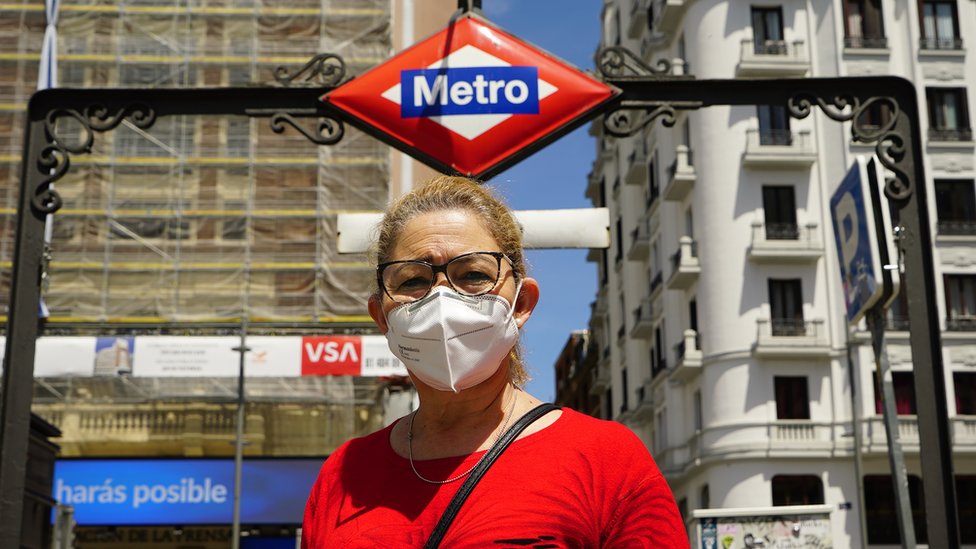 Женщина в маске у станции метро в Мадриде