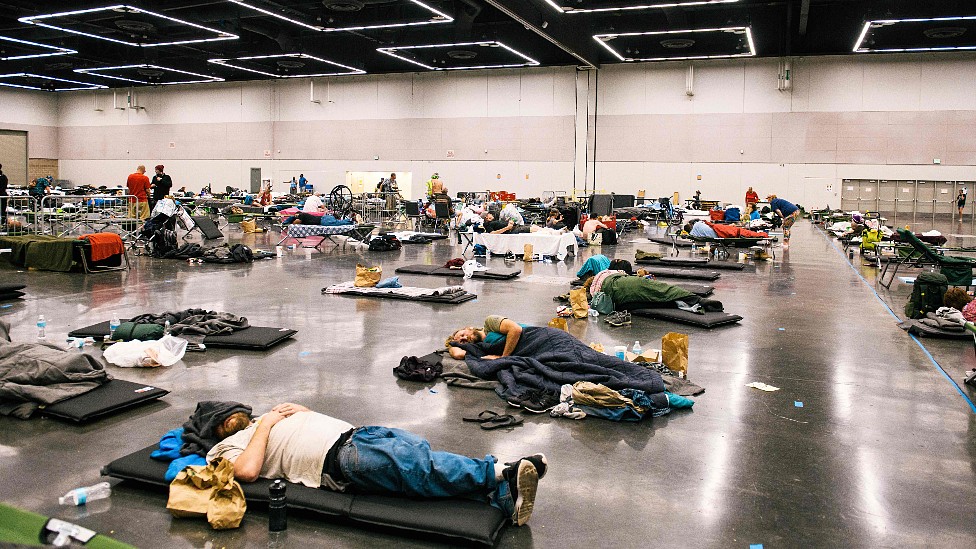 Personas en camas en un refugio durante la ola de calor en Oregon