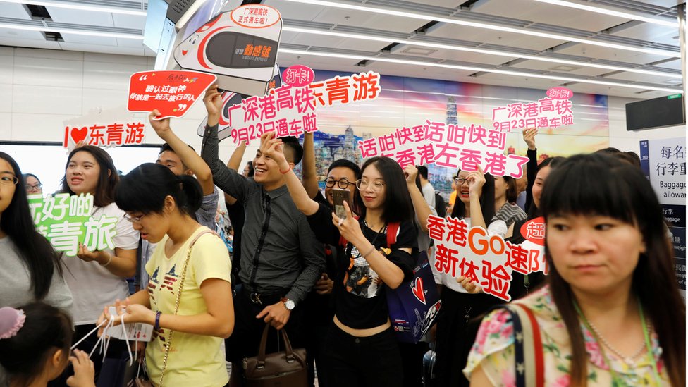 Tour guides greet passengers from China at West Kowloon Terminus at the first day of service of the Hong Kong Section of the Guangzhou-Shenzhen-Hong Kong Express Rail Link, in Hong Kong, China September 23, 2018. REUTERS/Tyrone Siu