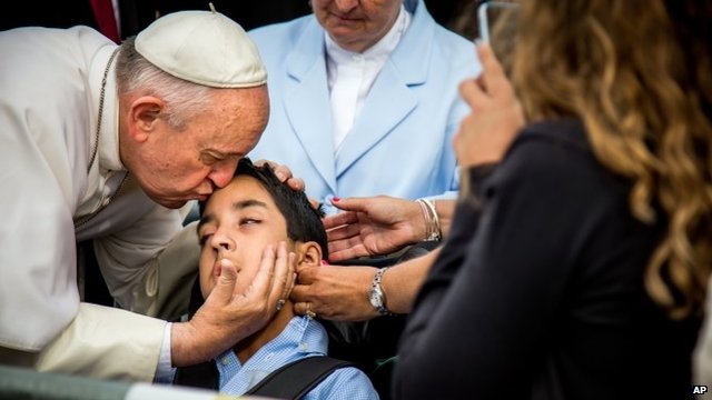 Pope Francis kissing child's head