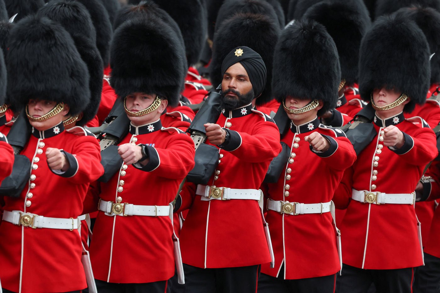 Guards officers march along the street during the coronation procession