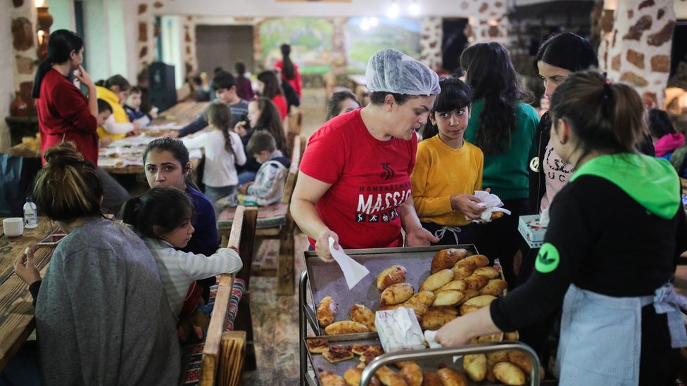 Refugees from Nagorno-Karabakh have their meals at a hotel in the Armenian town of Goris