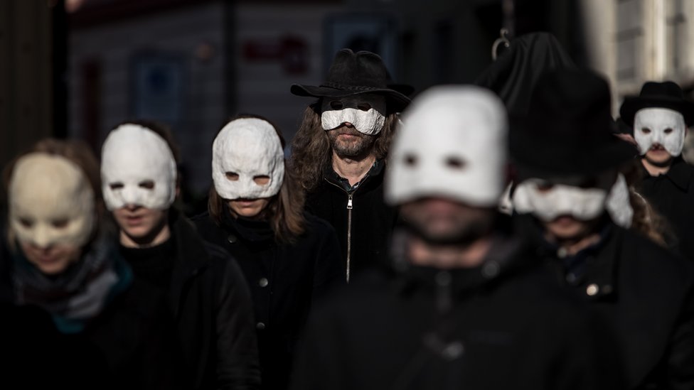 People wearing masks and walk through the streets in the Czech Republic