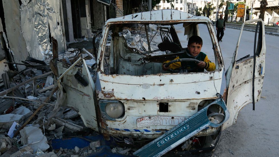 No es sorpresa que Siria ocupe el último lugar en el Índice Global de Paz. Niño juega dentro de un auto destrozado en Siria