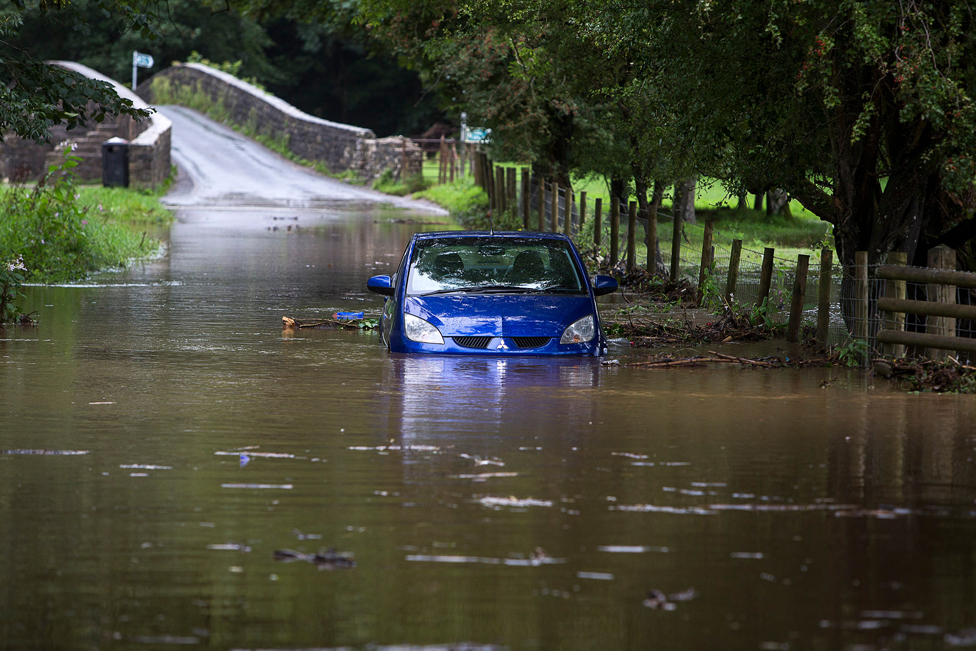A stranded car in flood water in Merthyr Mawr
