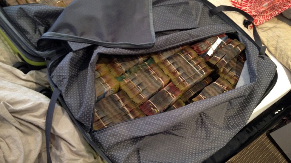 Bound bundles of cash in a bag at the drug raid