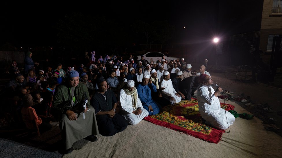 People kneeling during a dhikr session in Manenberg, Cape Town - South Africa