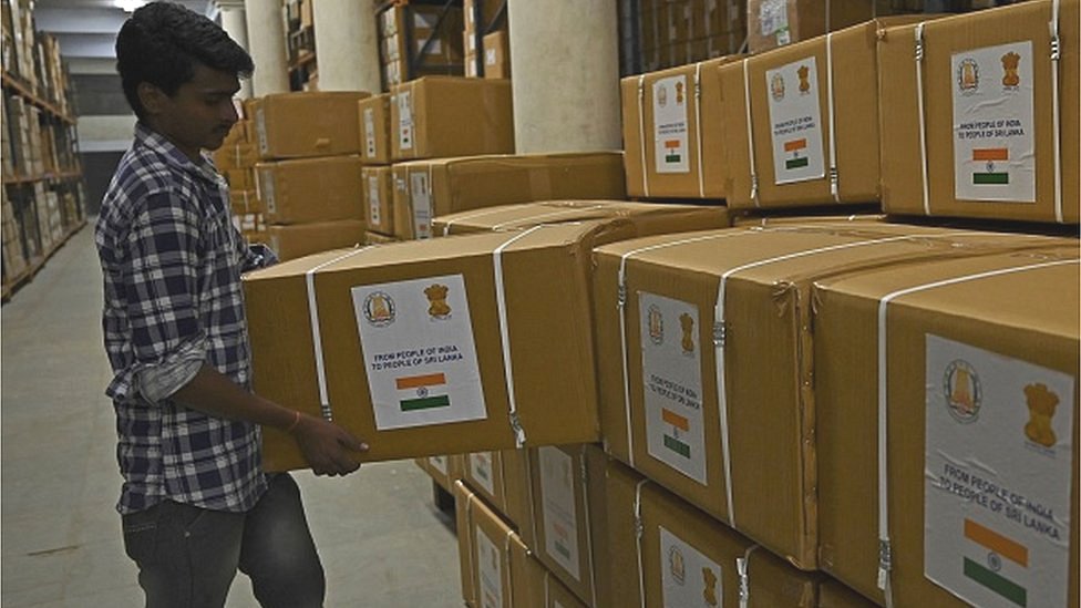 A worker stacks cartons of essential medicines to be shipped to Sri Lanka amid the country's ongoing economic crisis, in Chennai on May 15, 2022