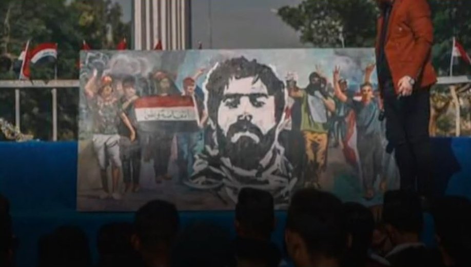 A banner, depicting Safaa Al-Saray's face and other young people protesting, at Baghdad's Tahrir Square
