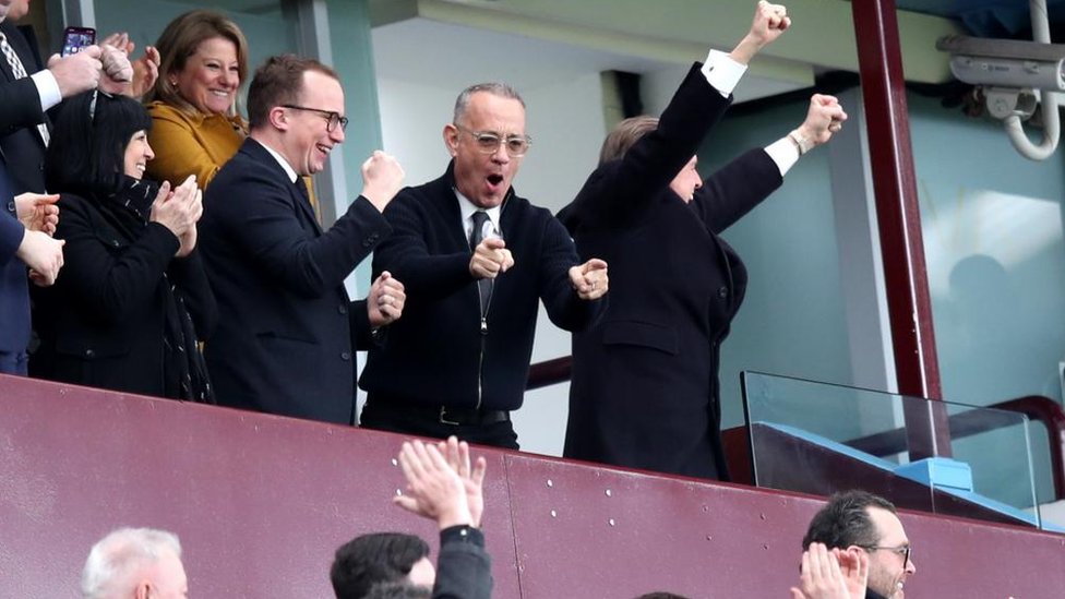 Tom Hanks cheering in football stand