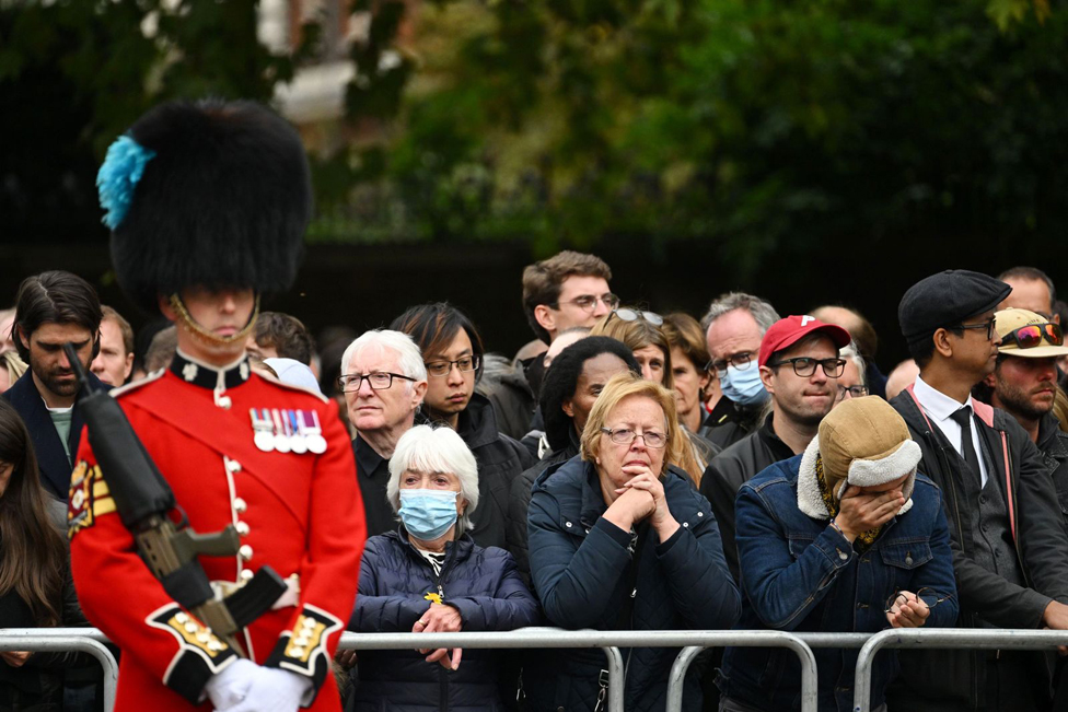 The crowd waits for the procession to arrive.