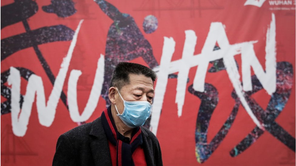 A man wears a mask while walking in the street on January 22, 2020 in Wuhan, Hubei province, China