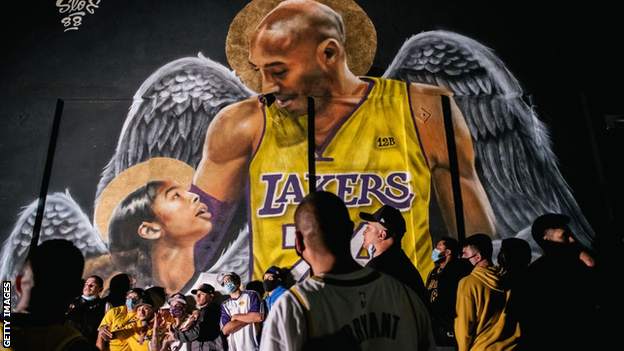 Lakers fans celebrate near a mural of Kobe Bryant and his daughter Gianna