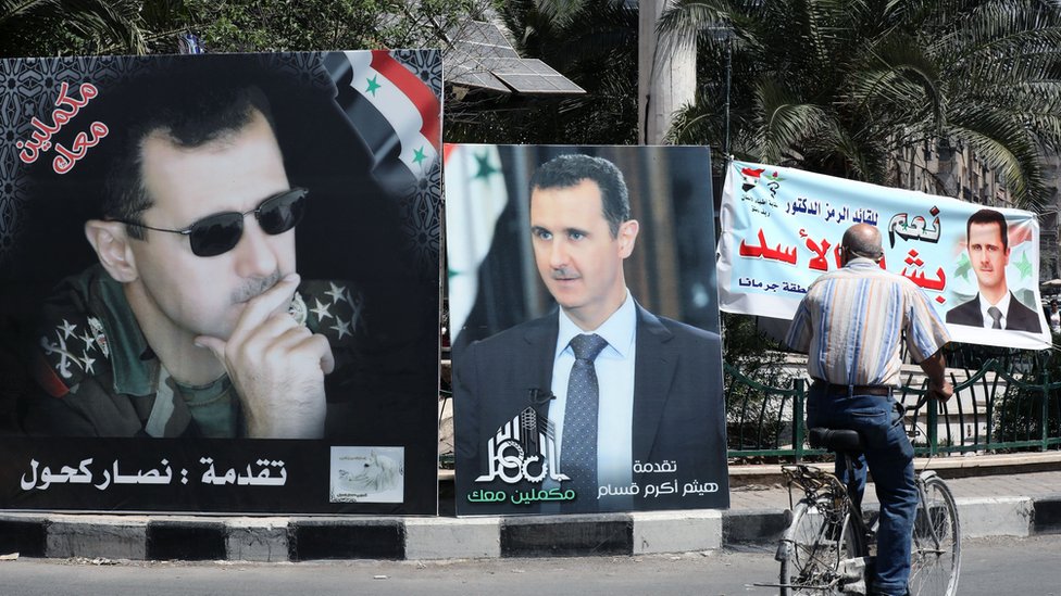 هل يأخذ كل السوريين الانتخابات الرئاسية الحالية على محمل الجد؟ 3 لافتات انتخابية مؤيدة لبشار الأسد تغطي شوارع دمشق