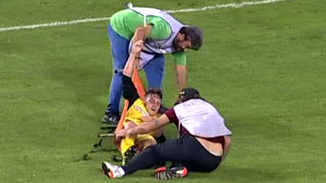 Ergotelis’ Leonardo Koutris is dropped to the floor by two stretcher-bearers