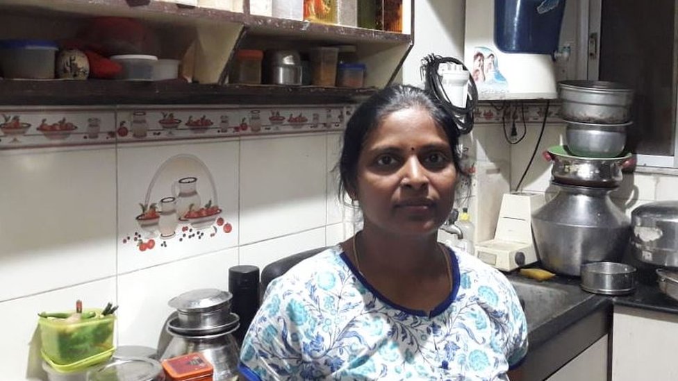 Shanthi standing in her kitchen