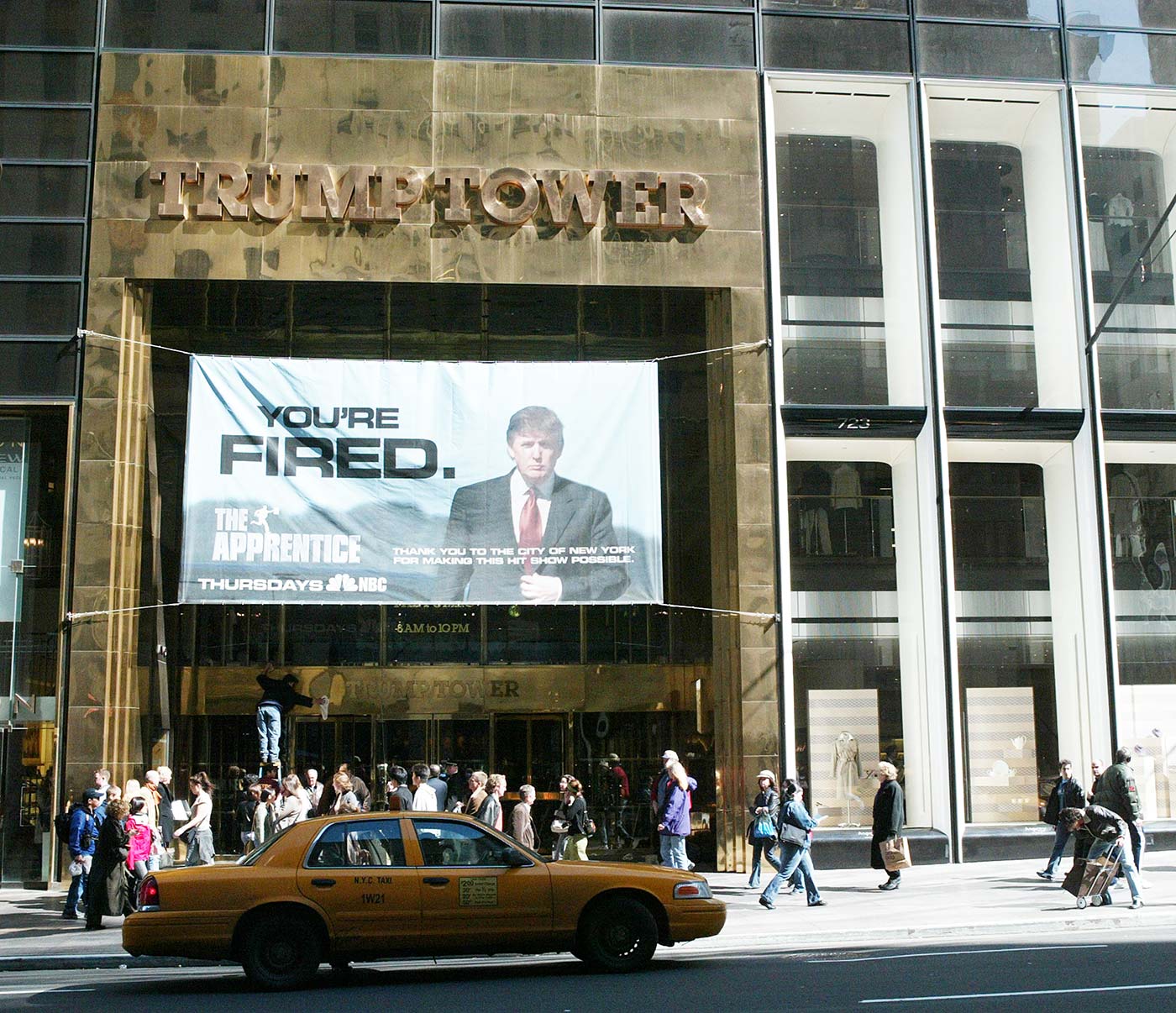A sign advertising The Apprentice television show hangs at Trump Towers on 15 April 2004 