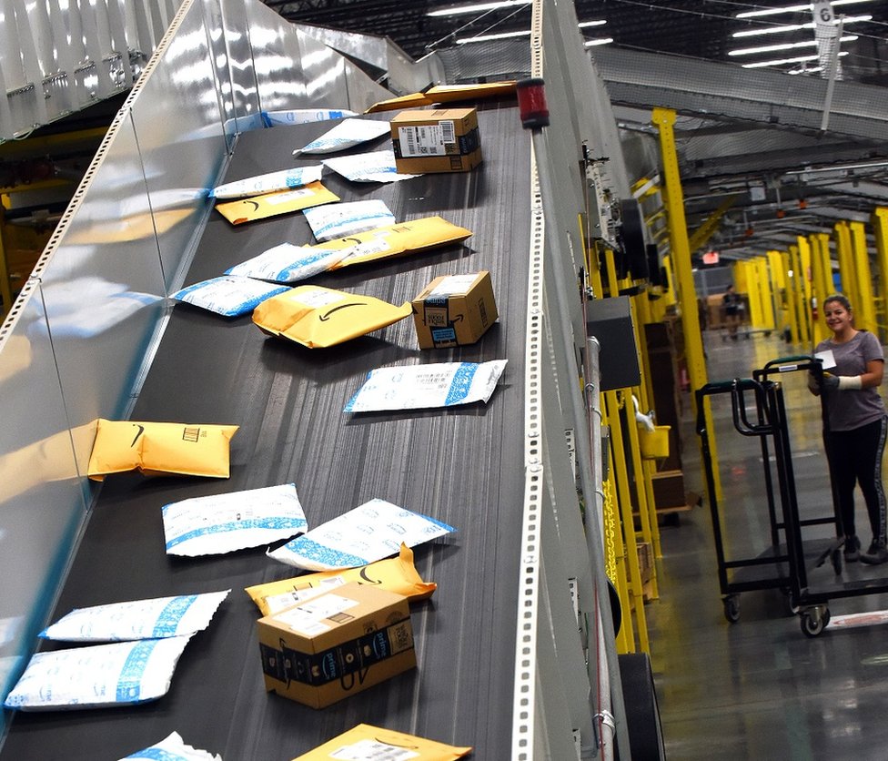 Customer orders are carried on a conveyor system at the newest Amazon Robotics fulfillment center during its first public tour on April 12, 2019 in the Lake Nona community of Orlando, Florida.
