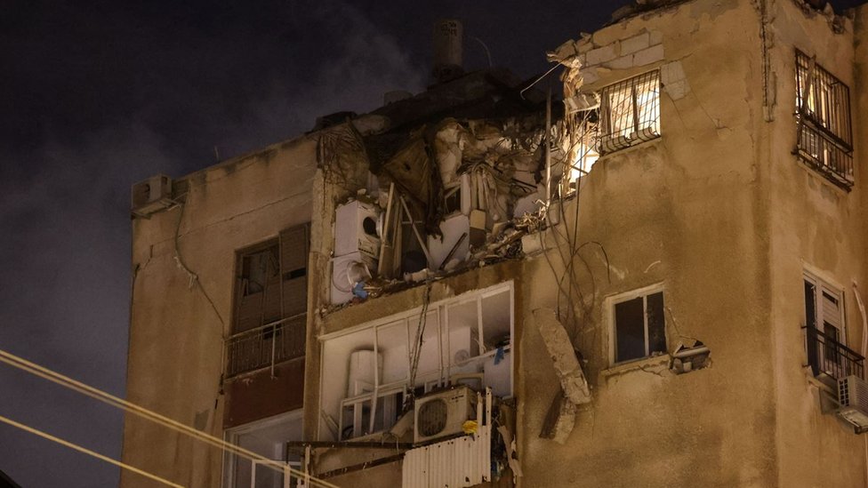 A building in Tel Aviv is damaged by a rocket fired by Palestinian militants from the Gaza Strip on 7 October