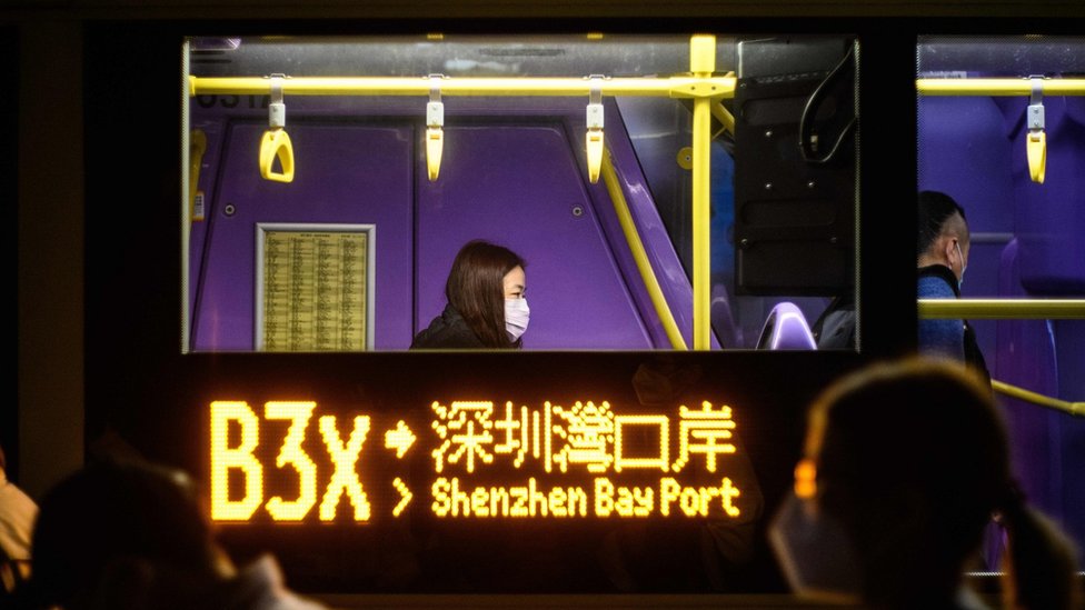 This photo taken on February 6, 2020, shows passengers on board a bus shortly before their departure from Tuen Mun in Hong Kong to Shenzhen, via the Shenzhen Bay Bridge.f Wuhan. - Hong Kong on February 8, 2020 began enforcing a mandatory two-week quarantine for anyone arriving from mainland China, a dramatic escalation of its bid to stop the deadly new coronavirus from spreading.