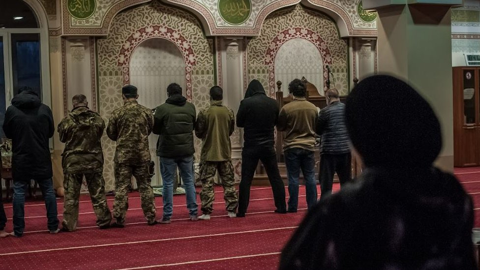 Men praying in a mosque