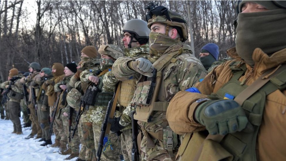 Servicemen of Ukraine's Azov Battalion pray in the Ukraine's second-biggest city of Kharkiv on March 11, 2022.