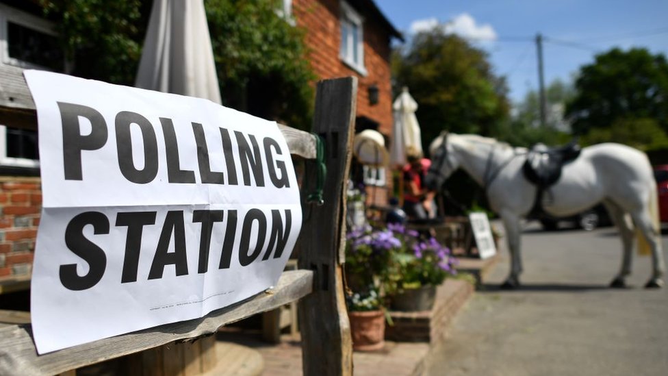 Polling station with a horse outside it
