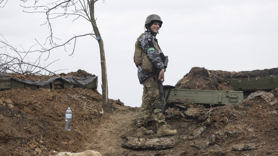 A Ukrainian soldiers guards a defensive position in the Donbas