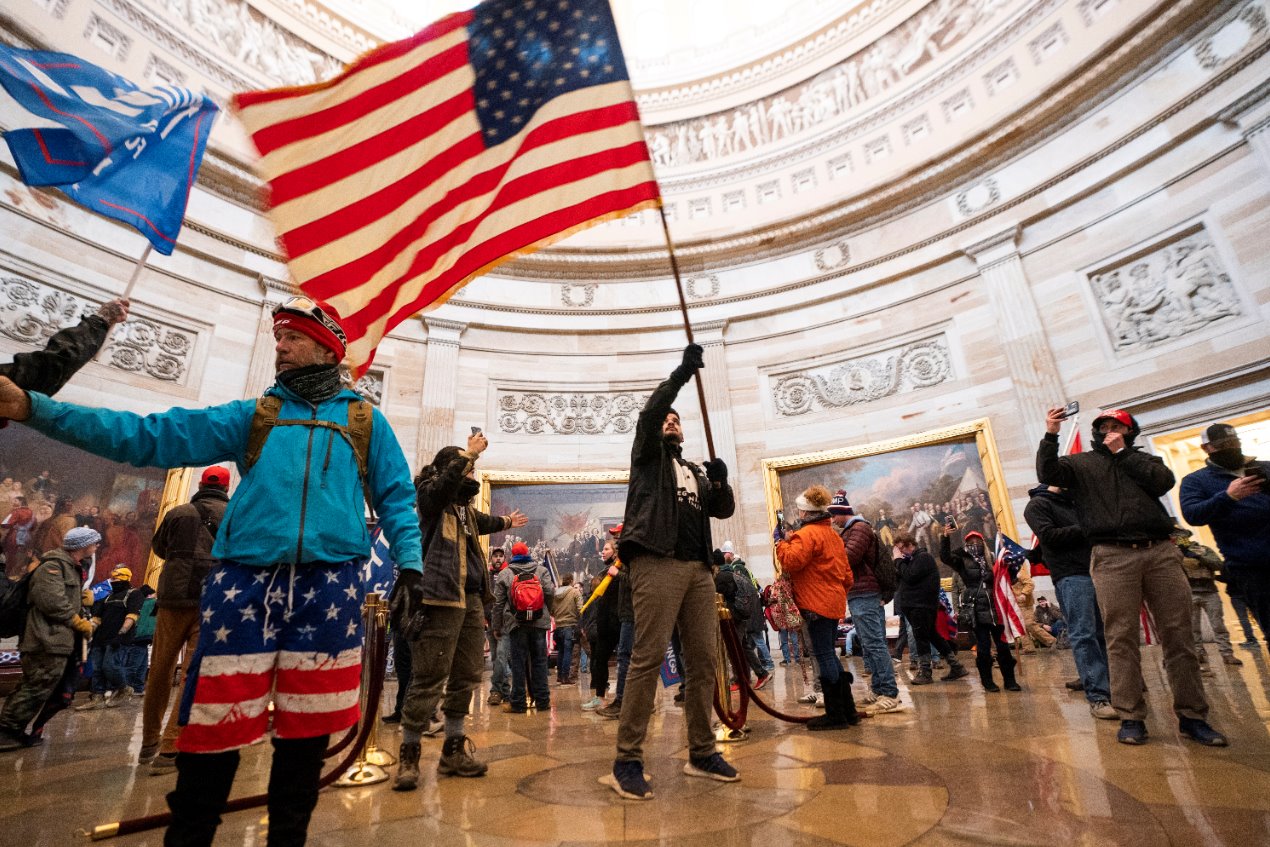 Protesters fill the American Capitol building with an American flag