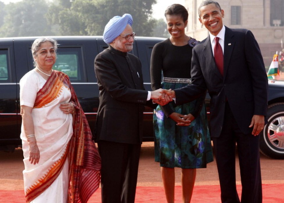 PM Manmohan Singh shakes hands with US President Barack Obama, as their better halves