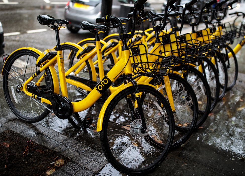 A row of Ofo dockless sharing bicycles on a London pavement in August 2018