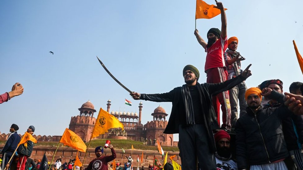 Protesters shout slogans in front of the Red Fort