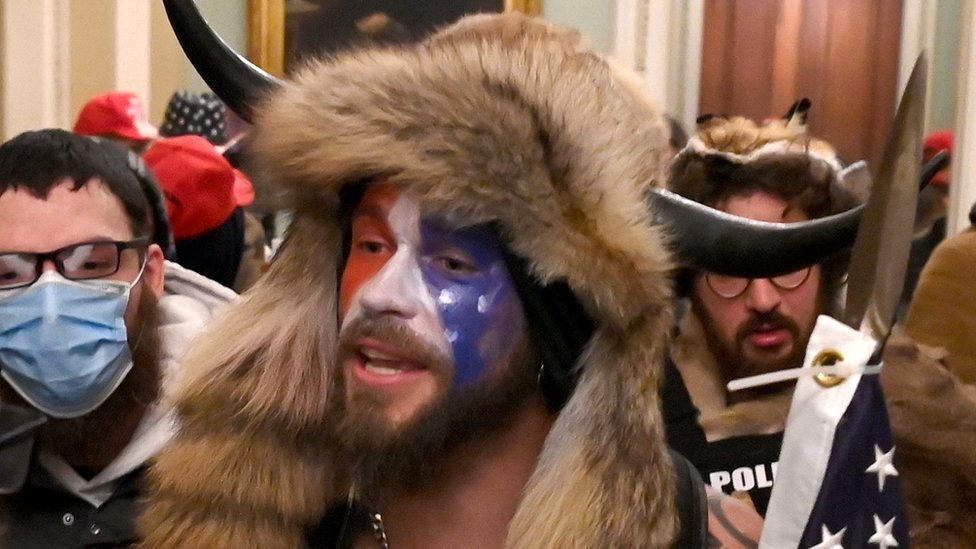 Face-painted man in horned fur cap at Capitol riot supports Trump