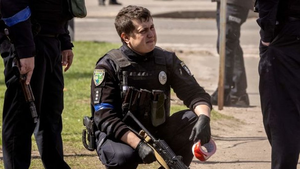 Ukrainian policeman after rocket hits Kramatorsk station