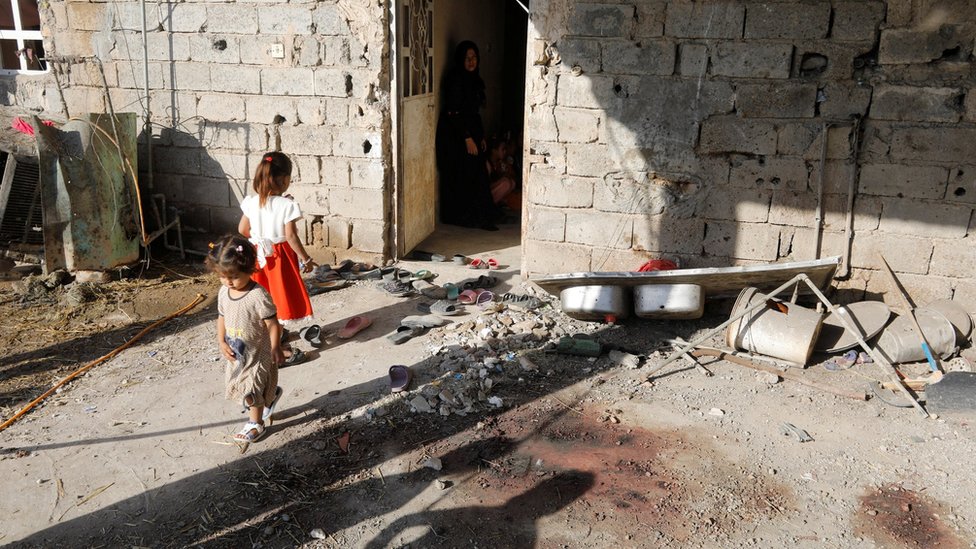 Дети видны возле дома, поврежденного в результате ракетного обстрела, в Абу-Грейб, Багдад, Ирак (29 сентября 2020 г.)