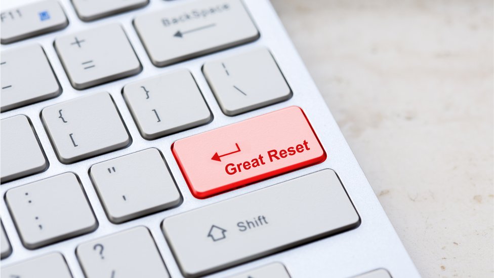 Silver grey keyboard close up with world global great reset enter- button - stock photo