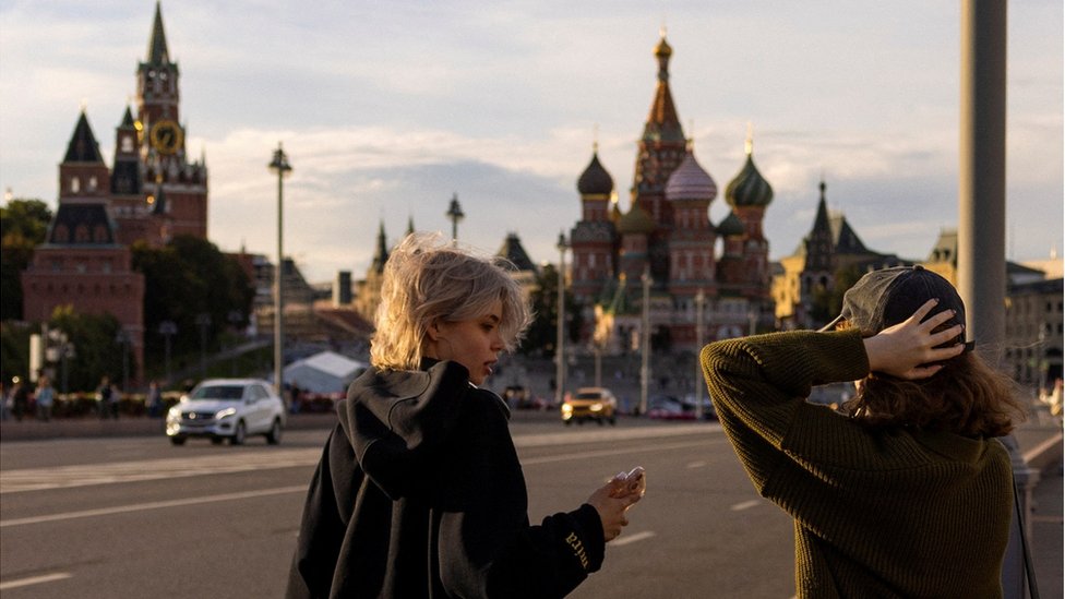 People on a bridge look on, near the Kremlin and Saint Basil's Cathedral in Moscow, Russia, August 12, 2024