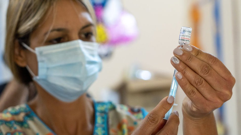 Nurse Monica Arrieta fills a syringe with Sputnik V vaccine