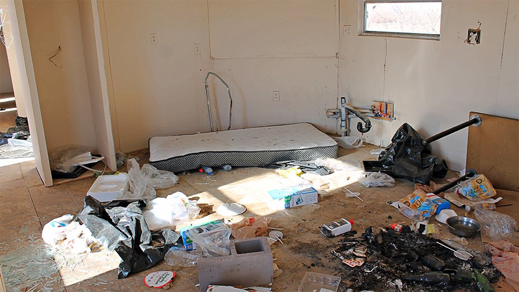 an eerie scene of chaos in a trailer, a naked mattress on the floor