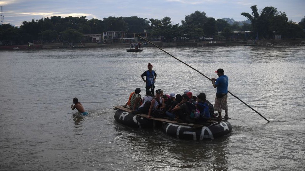 Migrantes cruzan el río Suchiate en balsas